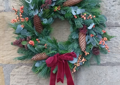 Orange ilex and pine cone wreath